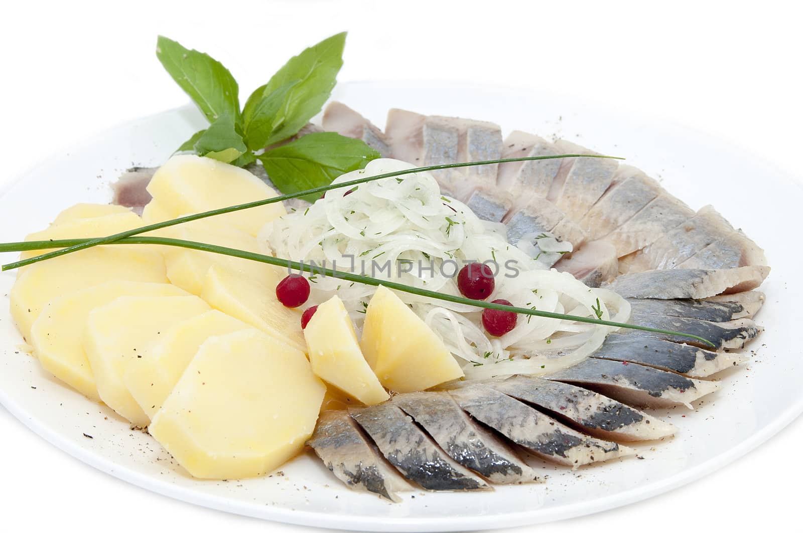 a plate of herring on a white background