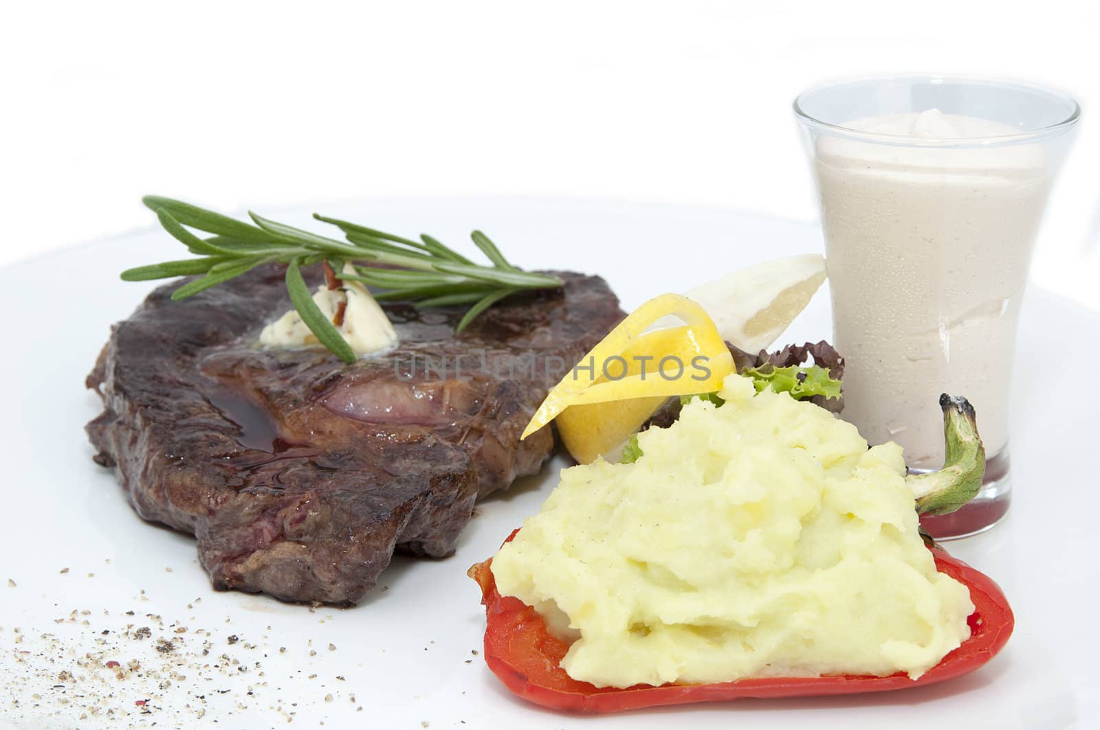steak and mashed potatoes with gravy on a white background