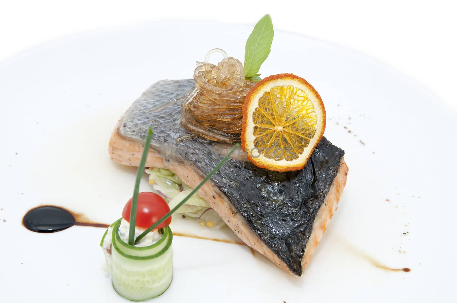 salmon steak in a restaurant and the sauce on a white background