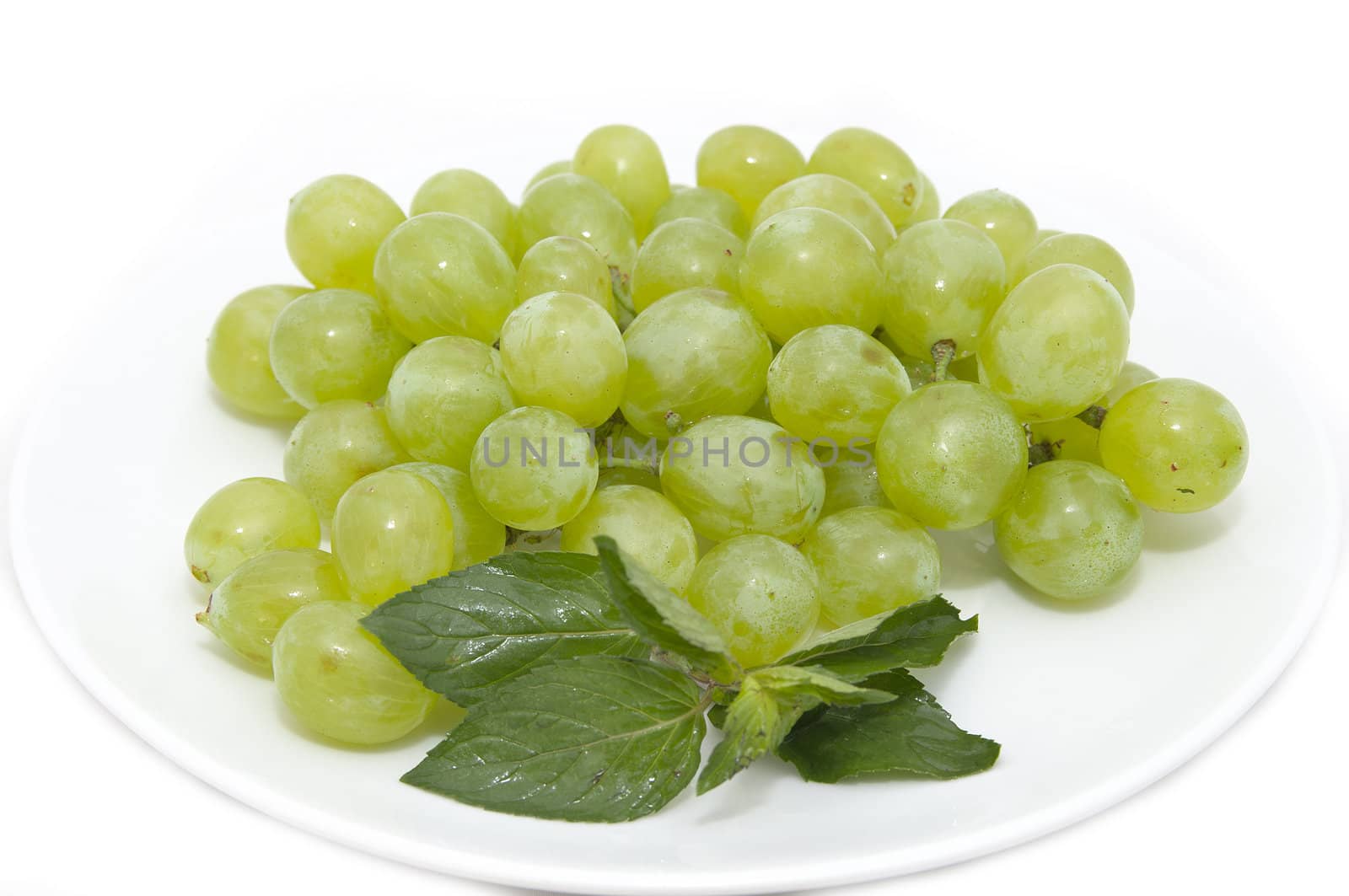 Grapes on a platter at the restaurant on a white background