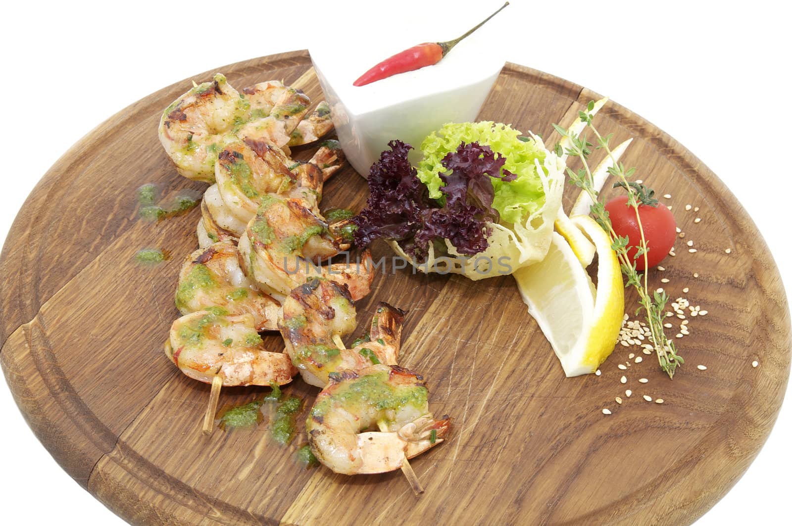 grilled shrimp with a salad on a wooden plate