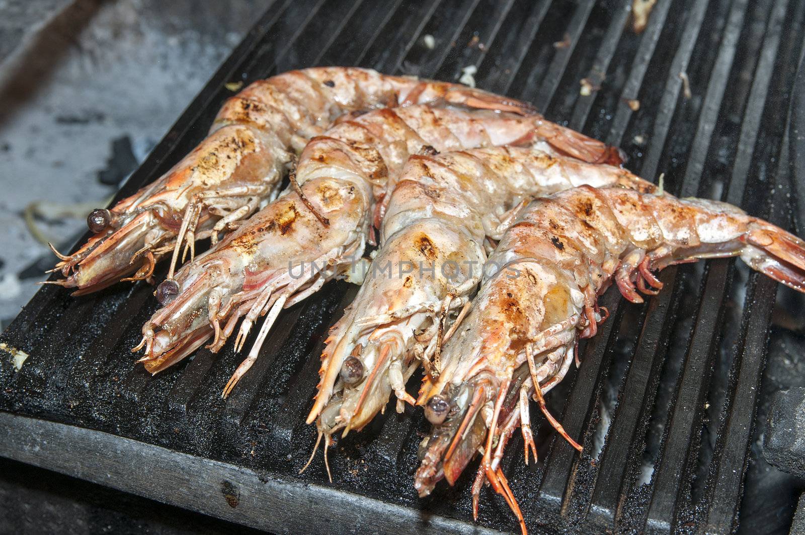 cooking shrimp on the grill in the restaurant
