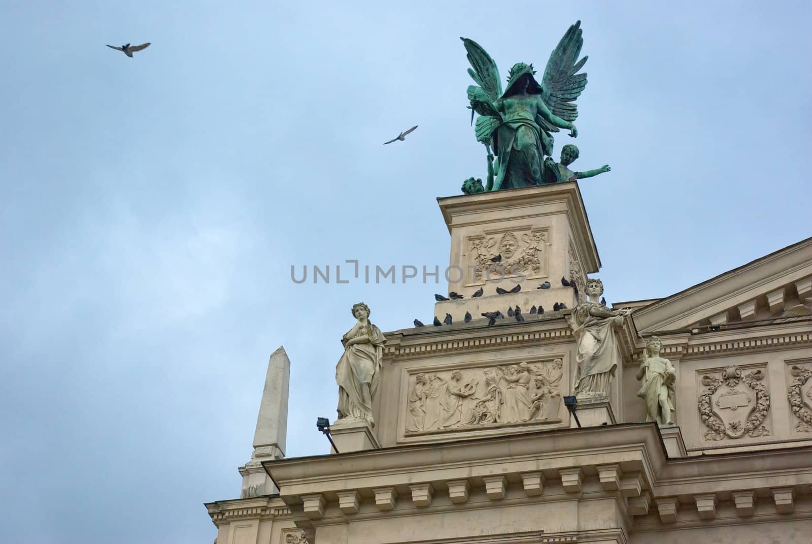 statue of an angel with wings of an architectural element