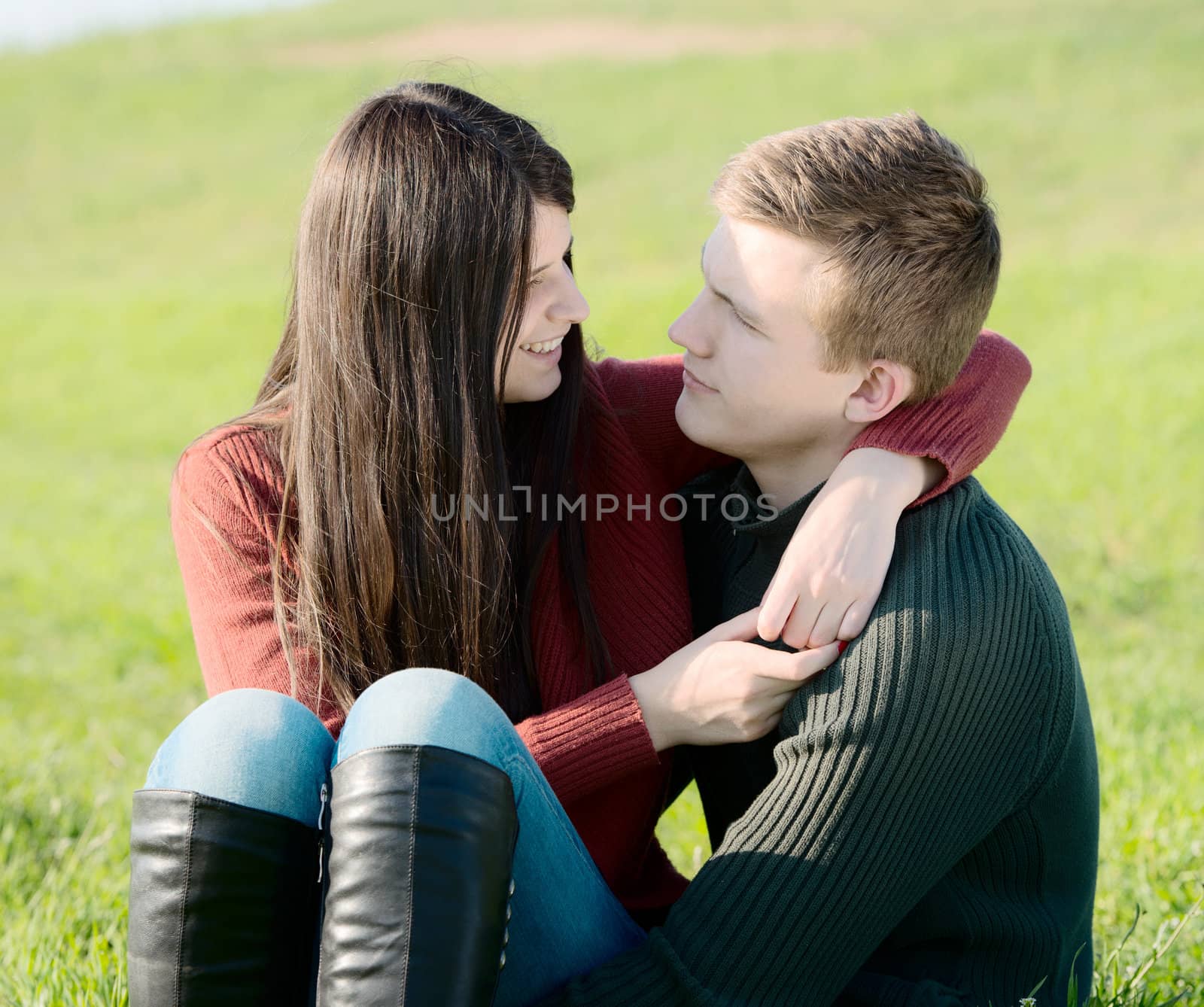 Young couple having fun outdoors on the meadow