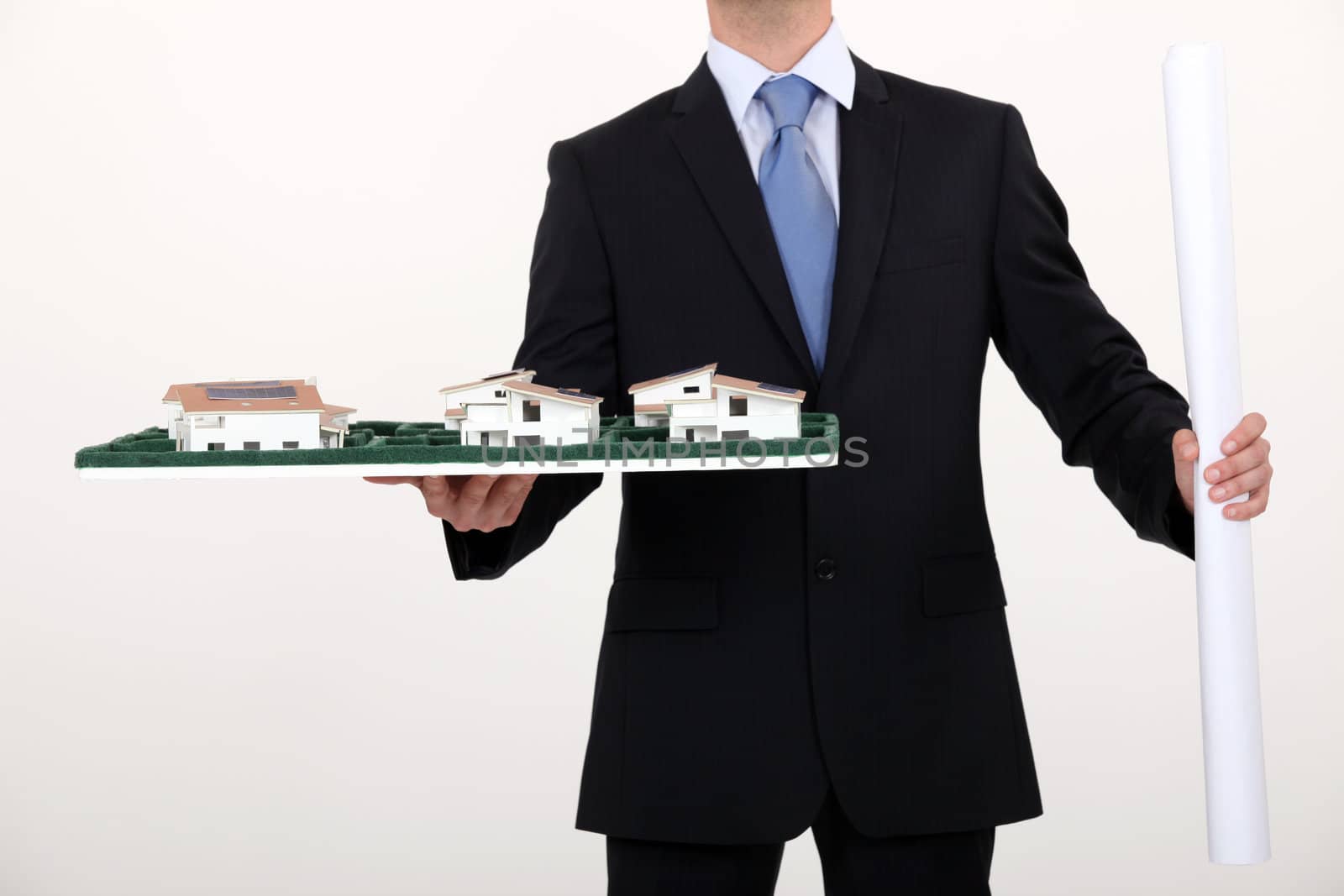 businessman holding an architectural model by phovoir