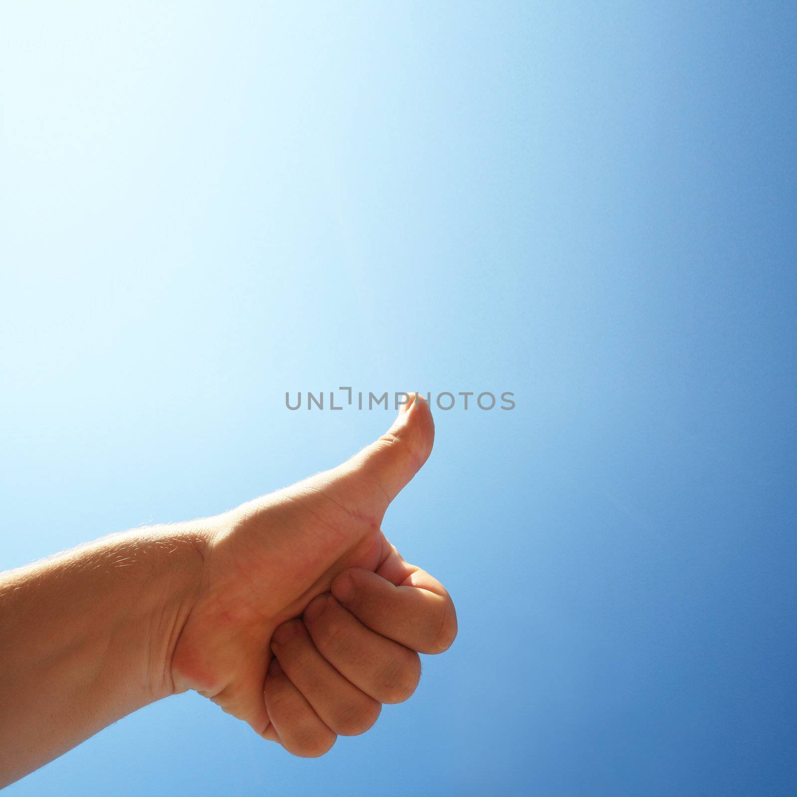 men's hand make thumbs up on blue sky