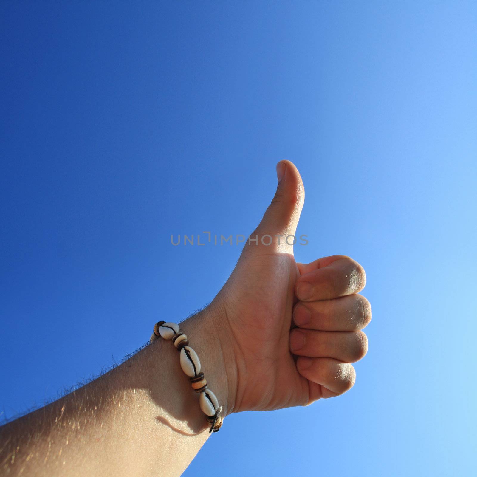 men's hand make thumbs up on blue sky