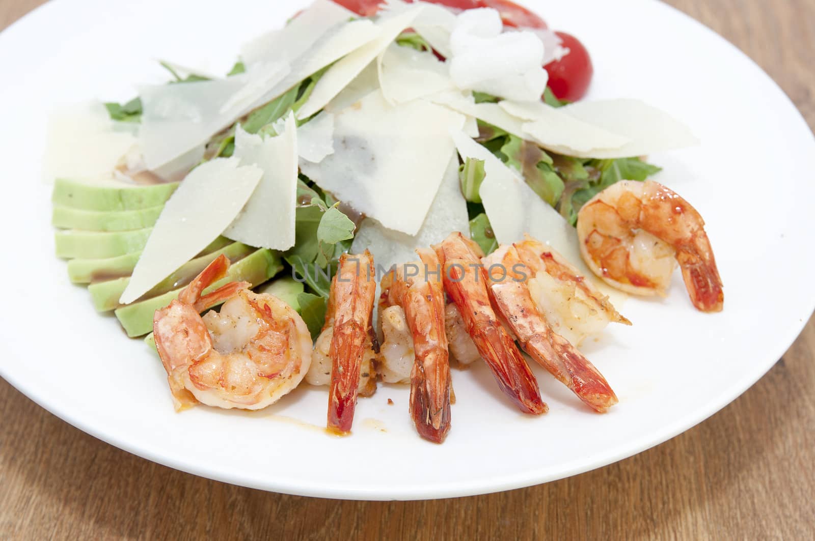 arugula dish with shrimp in a restaurant on the table