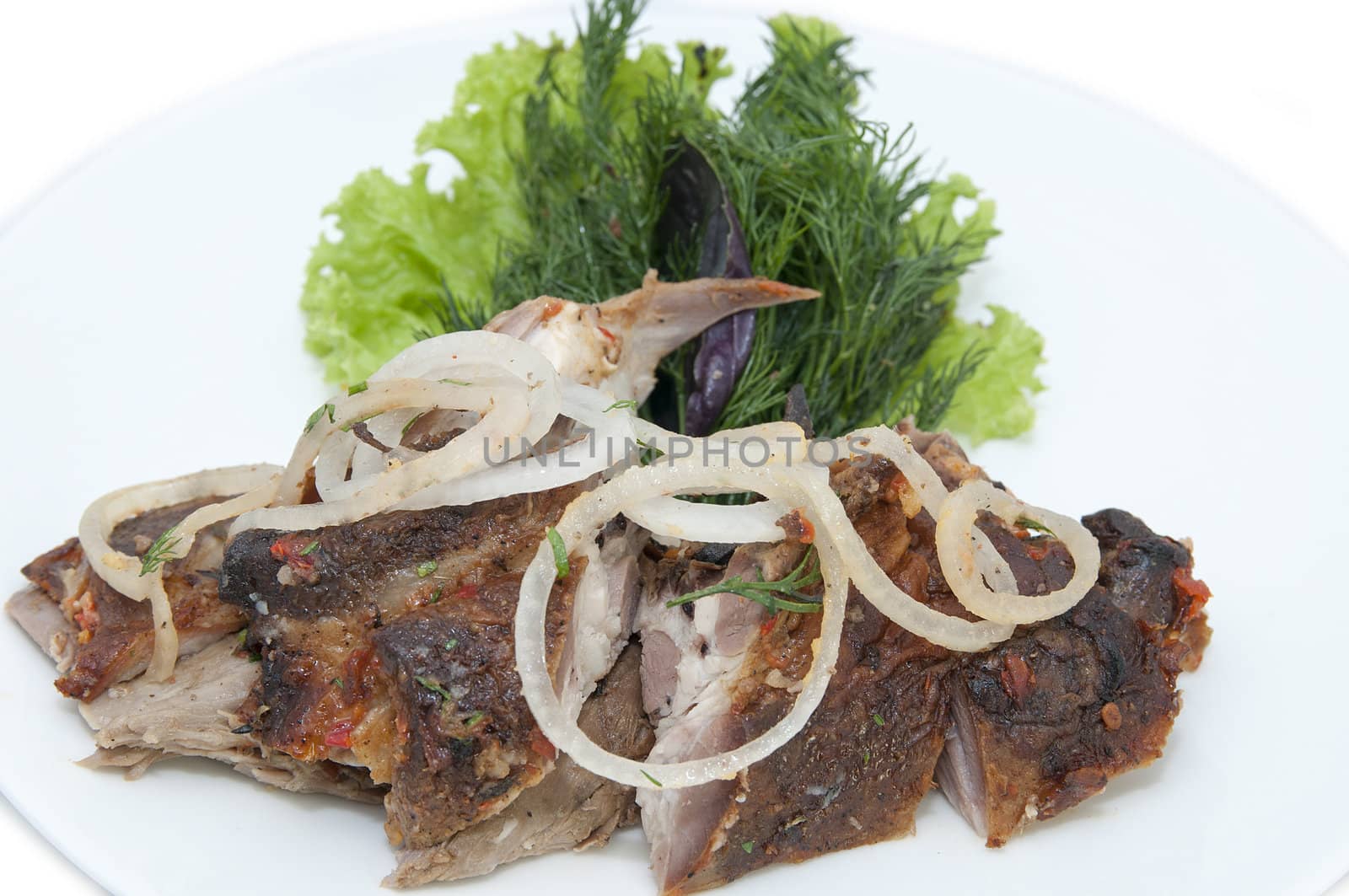 lamb with greens in a restaurant on a white background