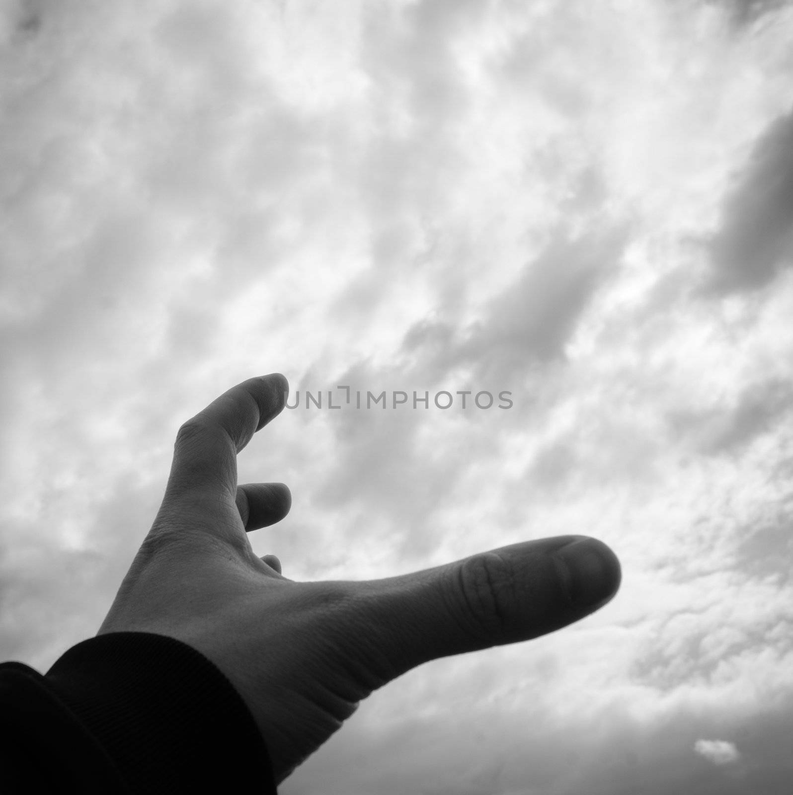 Man who extends his hand to sky and ask for help