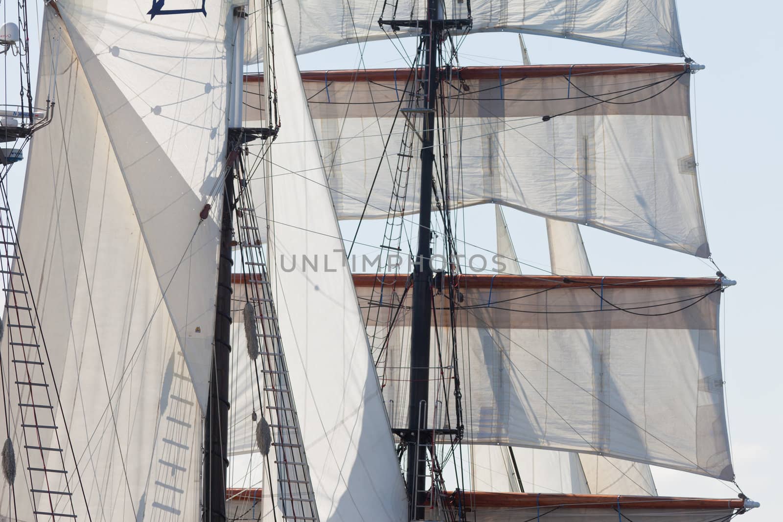 Marine or nautical background of a three masted barquentine yacht, square rigged on the foremast, with sails and rigging detail