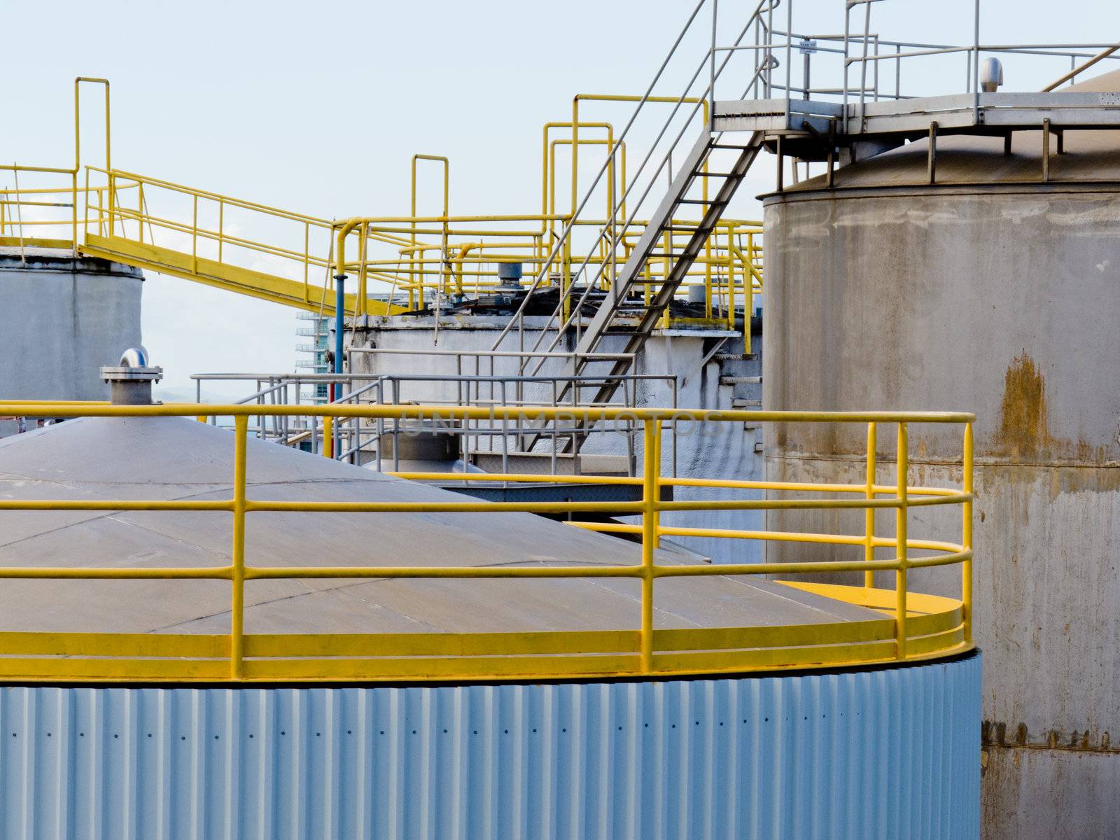 Group of large steel storage tanks at a refinery terminal used for storage and distribution of petrochemical products