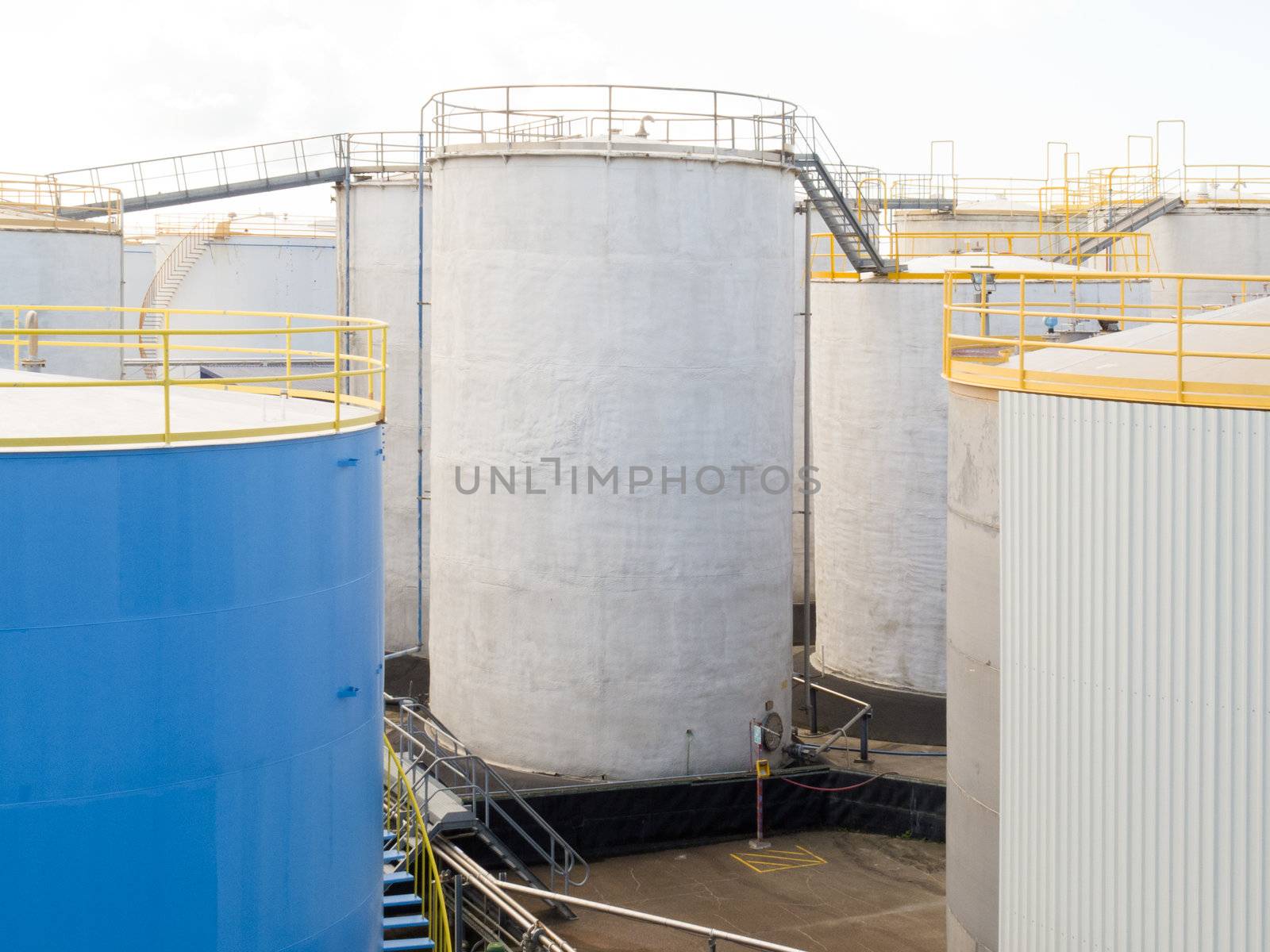 Group of large steel storage tanks at a refinery terminal used for storage and distribution of petrochemical products