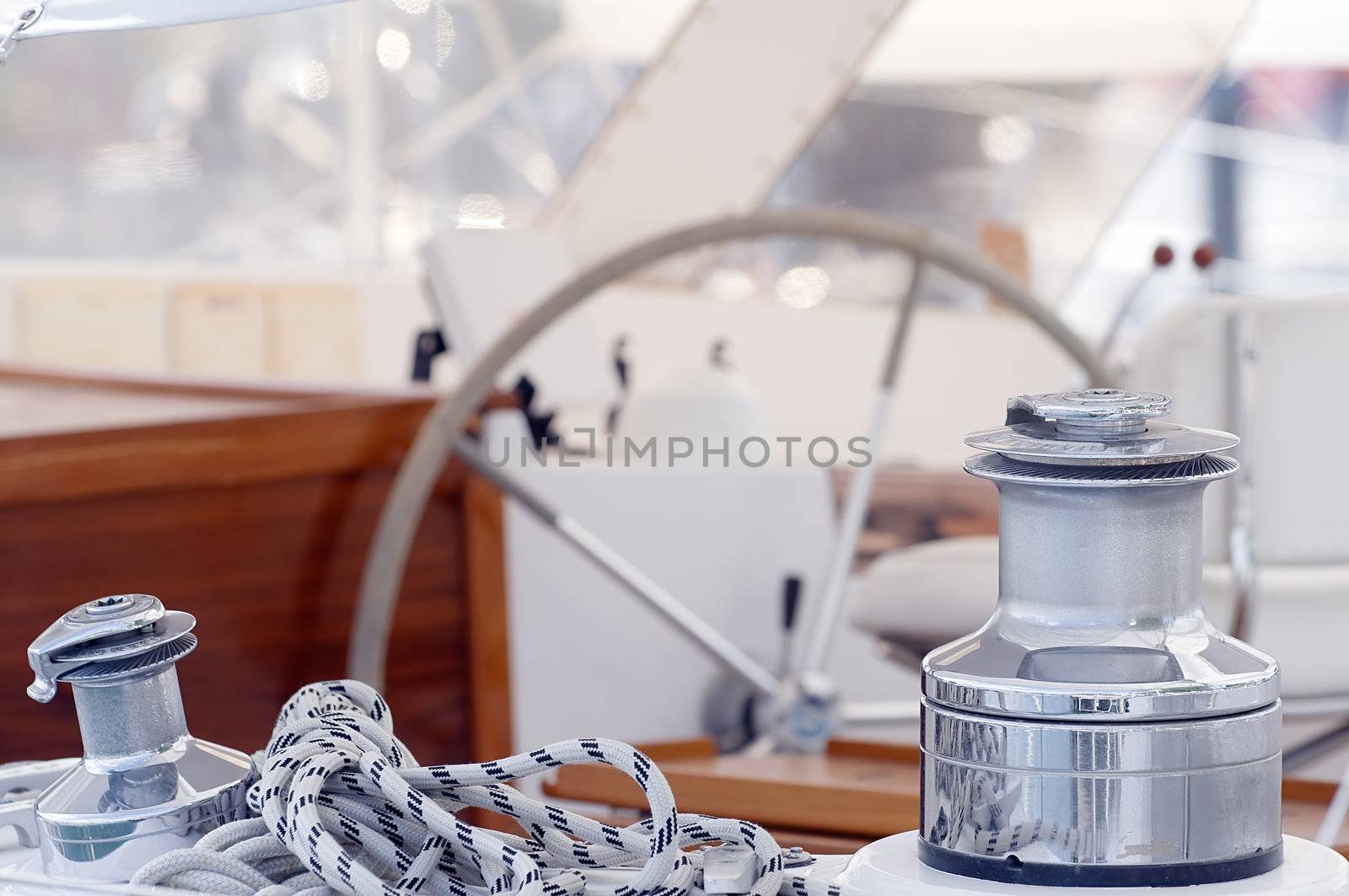 Detail of sailboat with winches, rope and  steering wheel