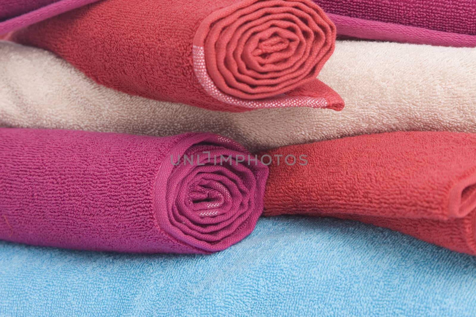 stacked of colorful towels on a white background