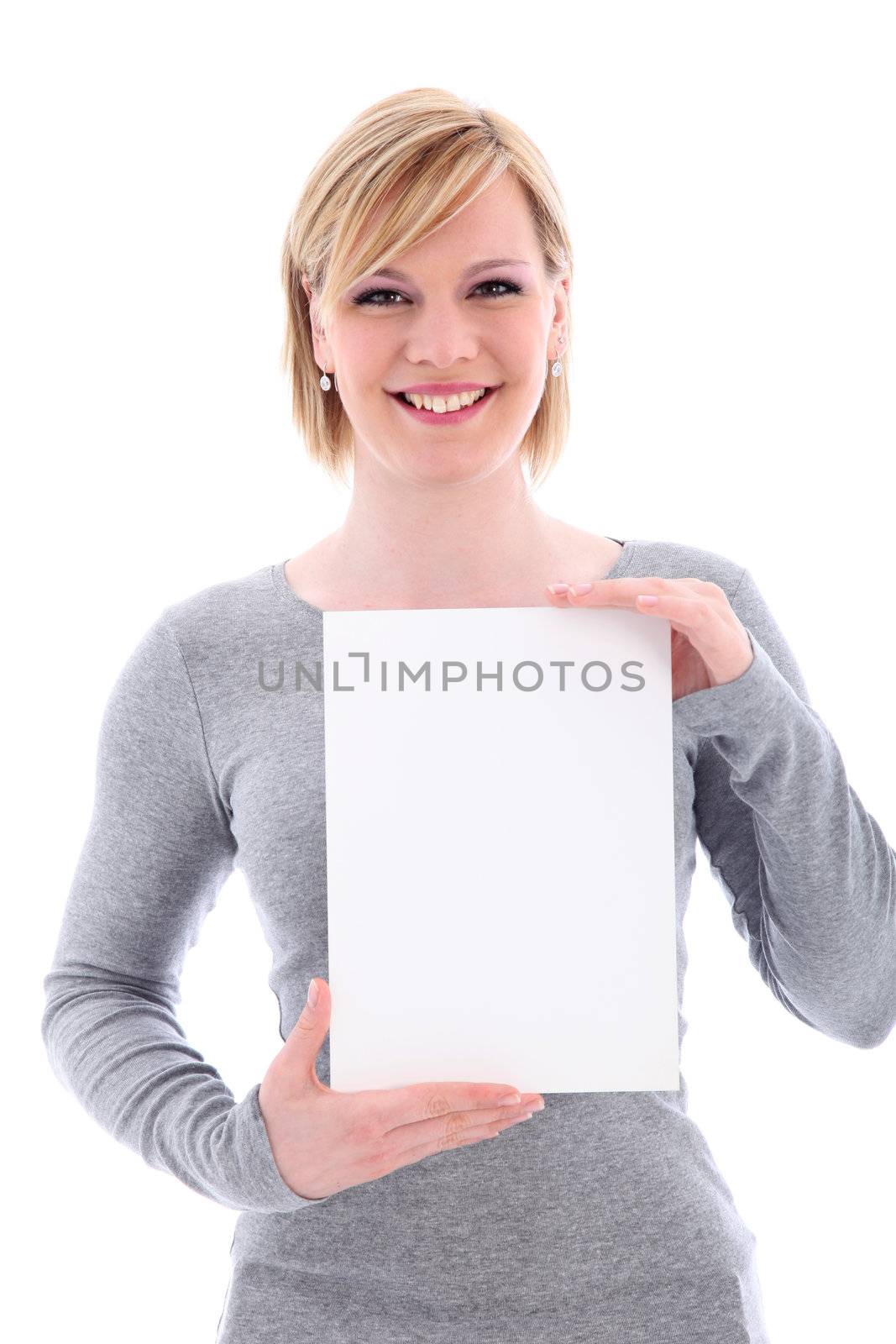 Friendly smiling young woman holding up a vertical blank white sign with copy space for your text or advertisement 
