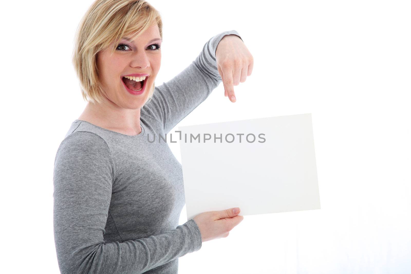 Laughing young woman pointing her finger to a blank sign that she is holding ready for your text isolated on white Laughing young woman pointing her finger to a blank sign that she is holding ready for your text 