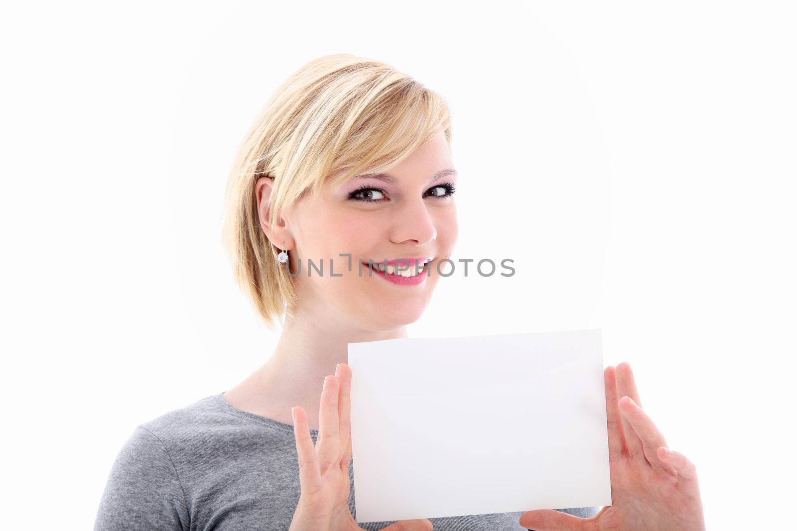 Friendly attractive blonde woman holding up a small blank sign for your text or advertisement isolated on white 