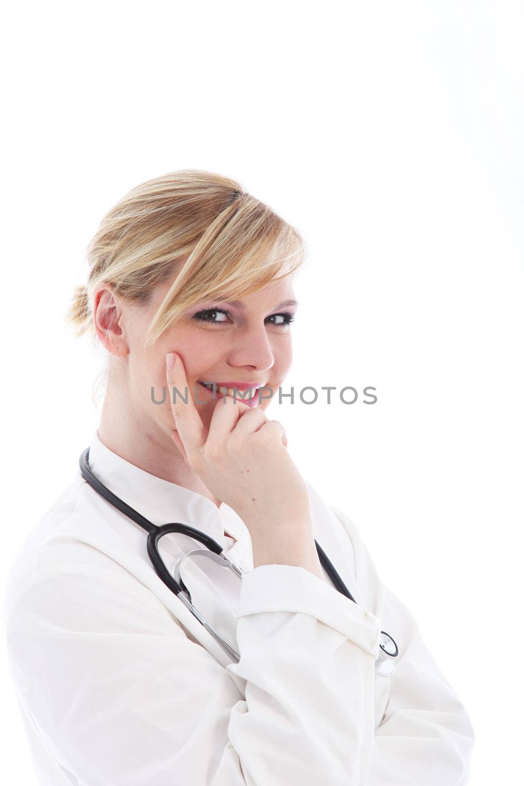 Smiling female doctor in a natural pose with her hand and finger against her cheek as though disturbed while thinking isolated on white 