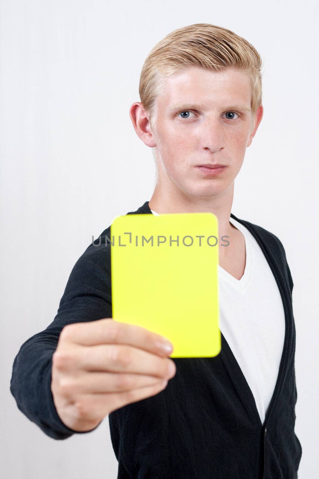 Attractive young man showing yellow card