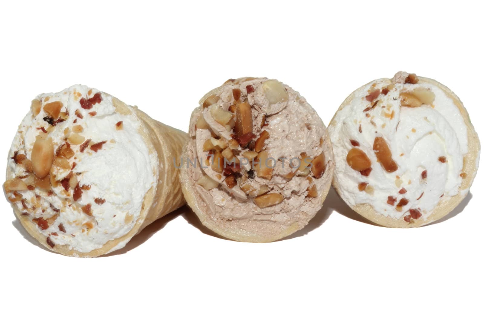 Three wafer tubules with a cream covered by nutlets on a white background
