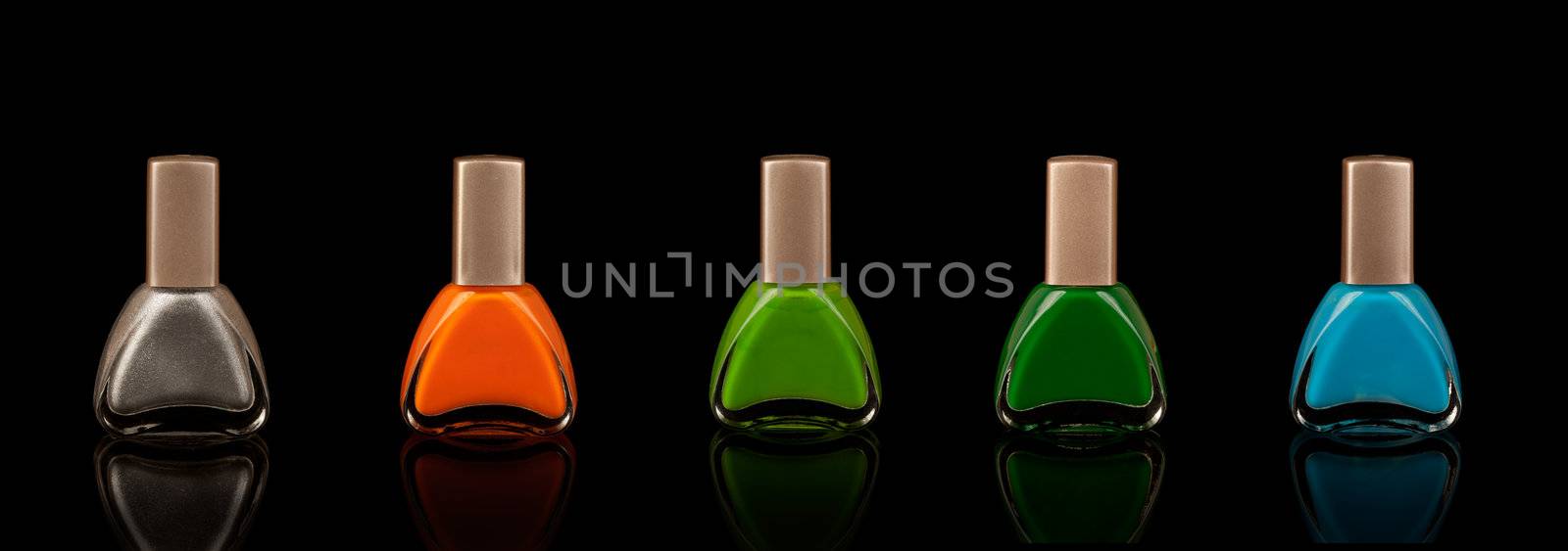 Nail polish in five colours with black background