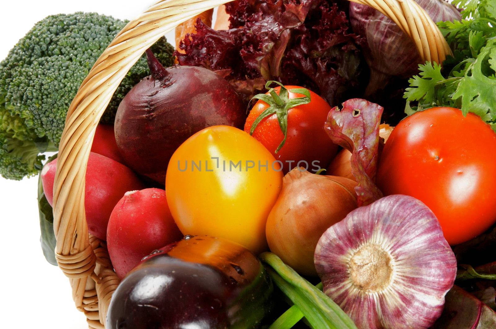Basket of Various Vegetables with Broccoli, radishes, lettuce, onions, leeks, beets, carrots, red tomatoes, yellow tomatoes, parsley close up
