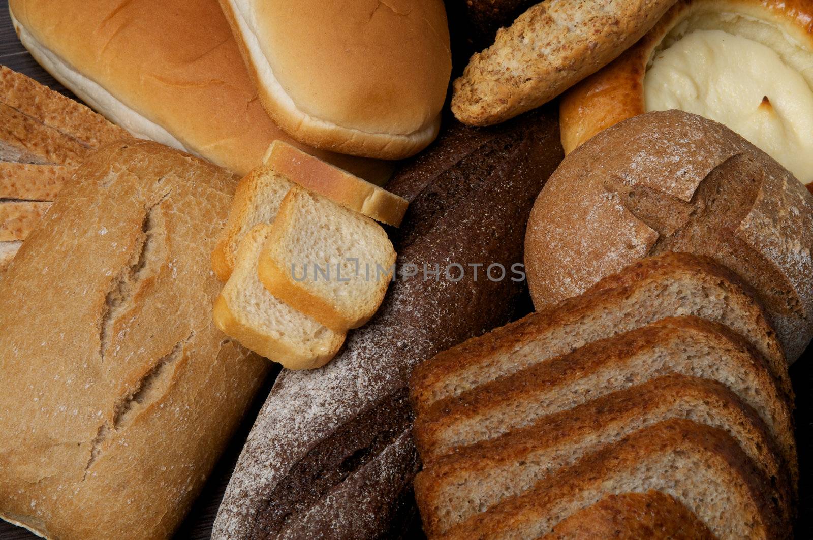 Background of Buns, Baguette, Rye and Whole Wheat Bread close up
