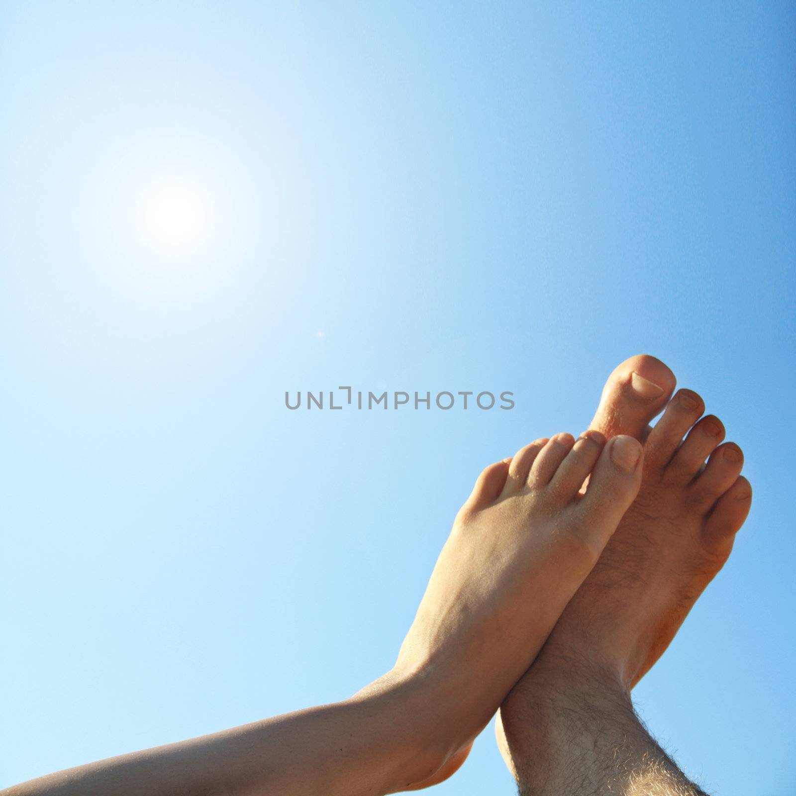 male and female legs on summer background by photochecker