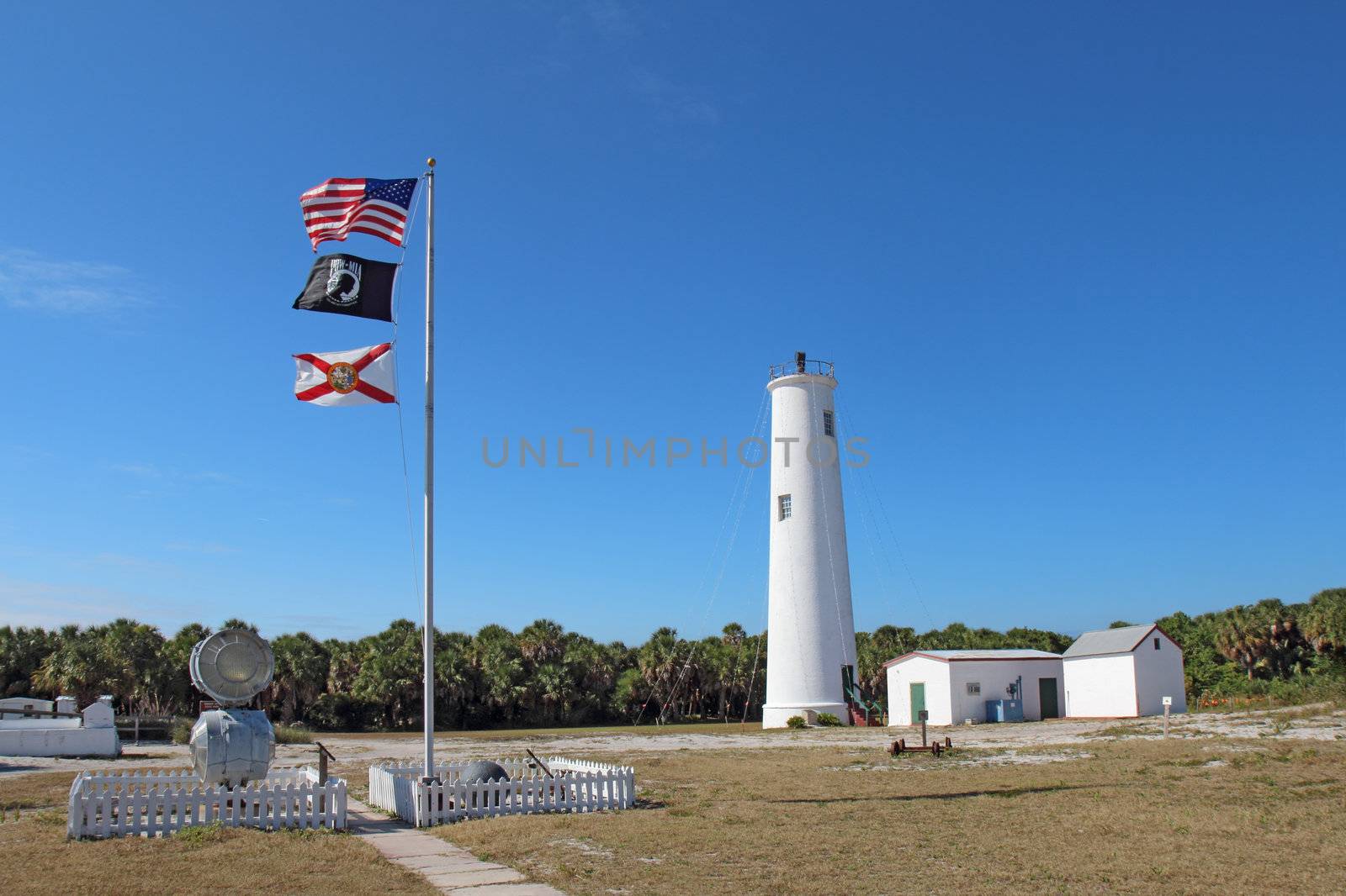 The Egmont Key lighthouse and flags in Tampa Bay, Florida by sgoodwin4813