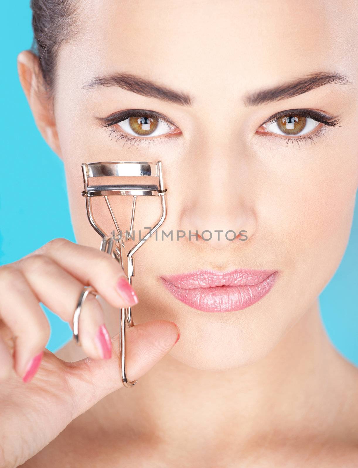 Pretty woman holding tool for eyelash