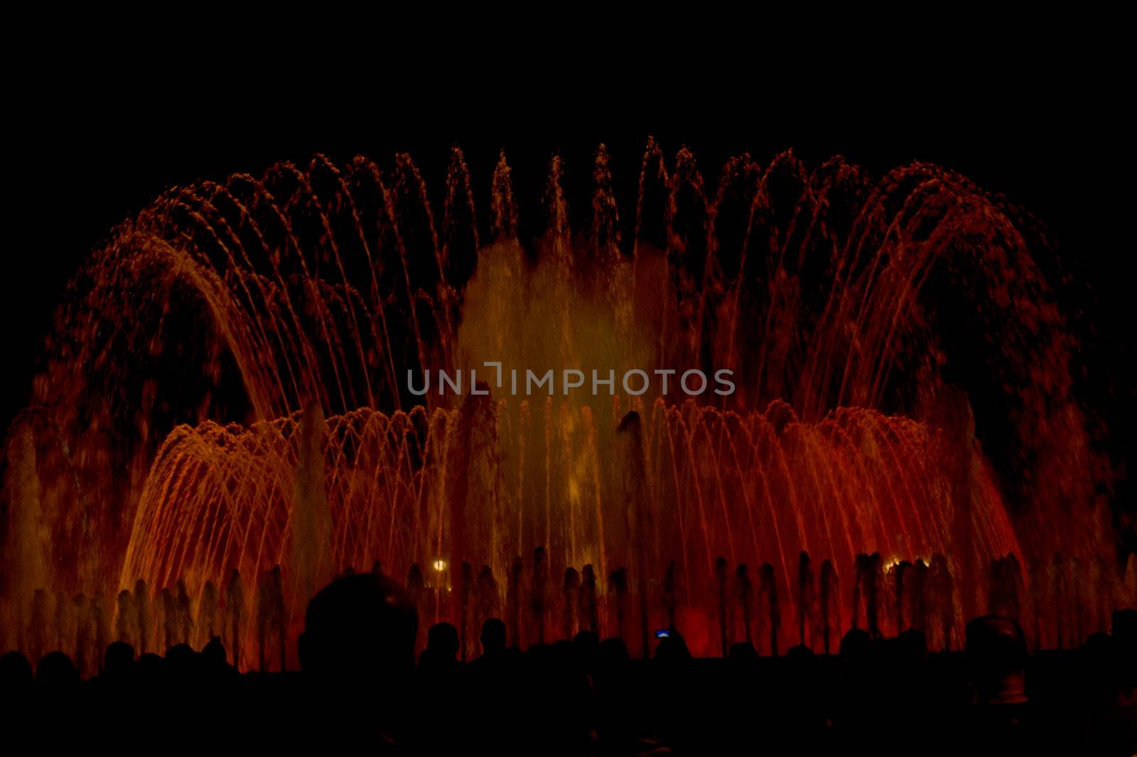 Colorful water fountain night show in Barcelona.