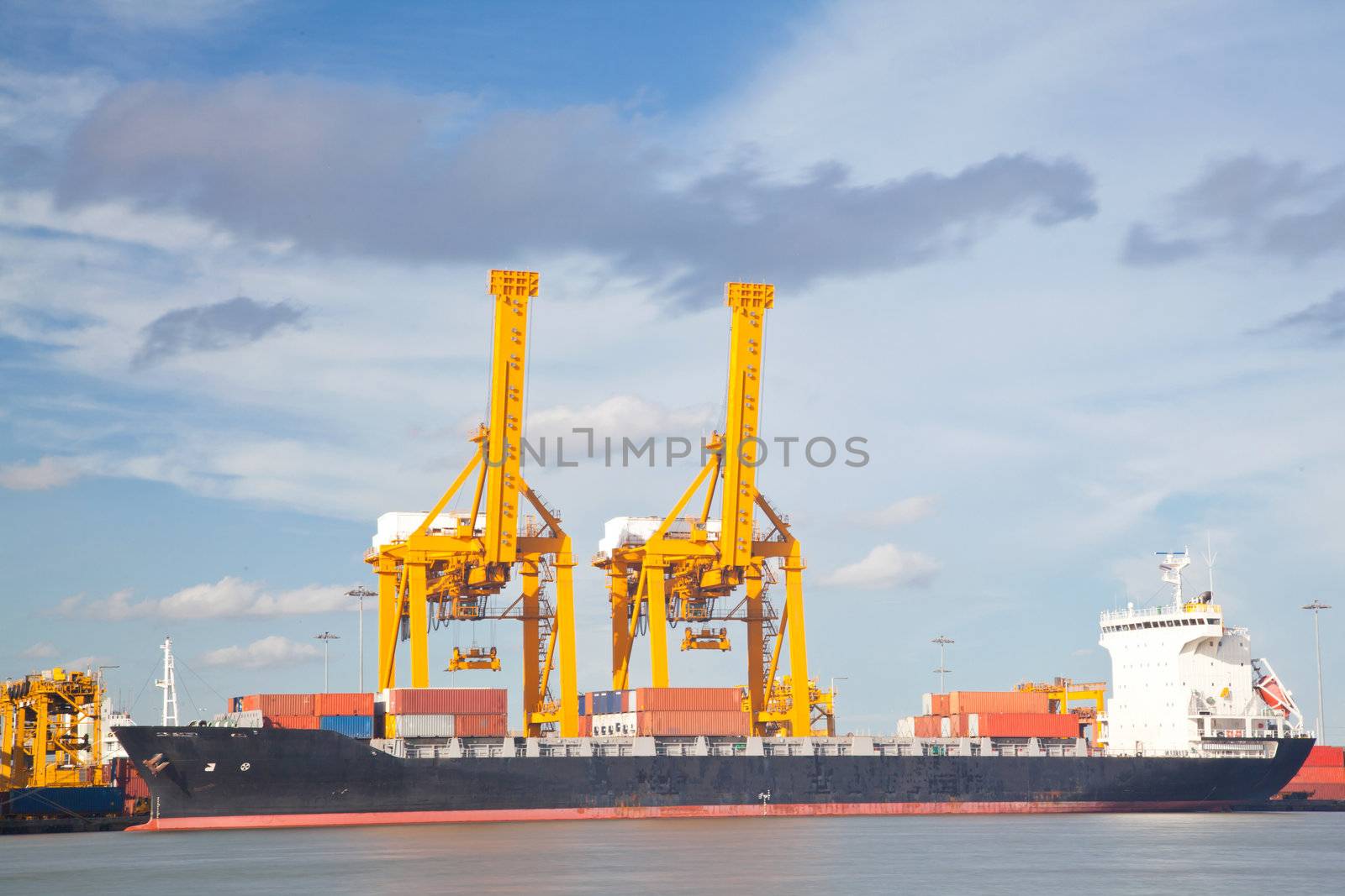Container Cargo freight Industrial ship with working crane bridge unloading and loading goods in Bangkok shipyard Terminal for Logistic Import Export background