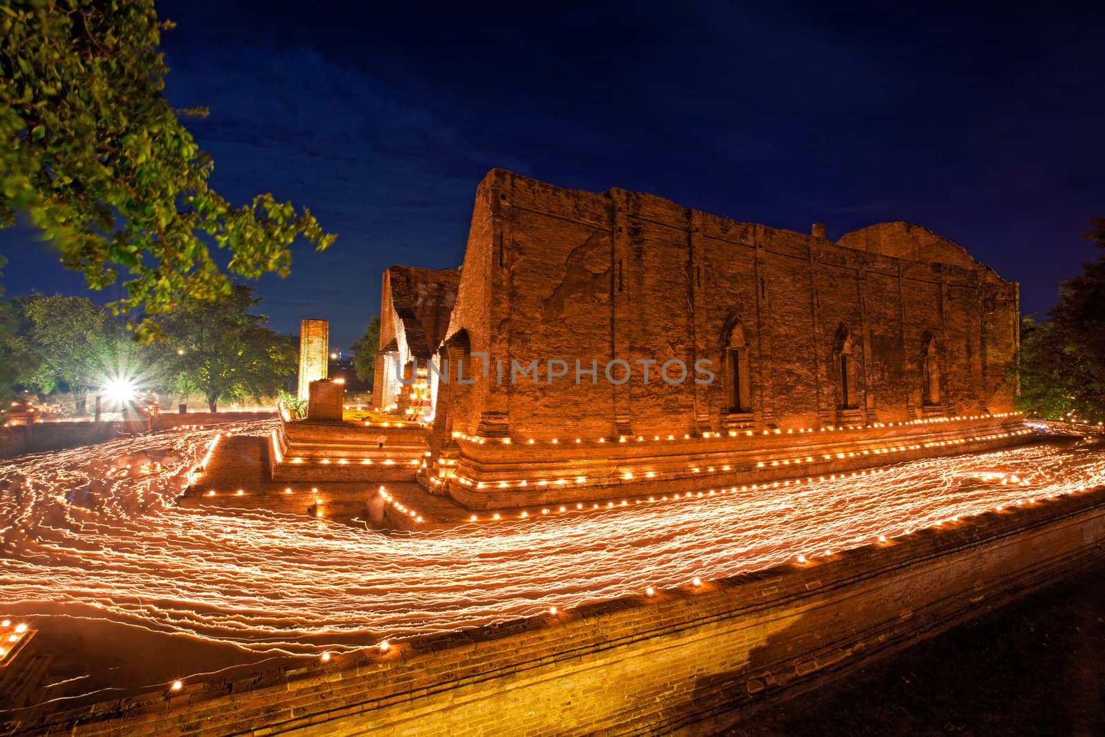 candle light trail of Buddhism Ceremony at temple ruin on Asalha Puja day