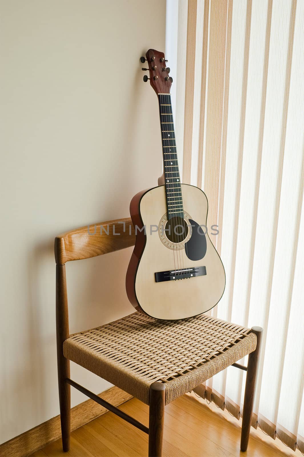 classical guitar on a modern chair
