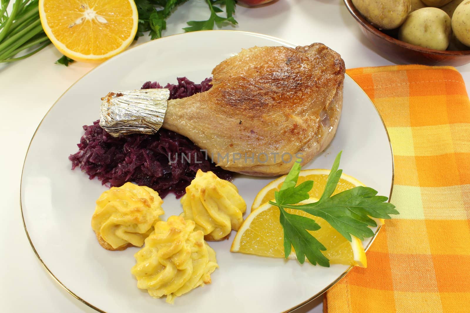 Duck leg with red cabbage and duchess potatoes