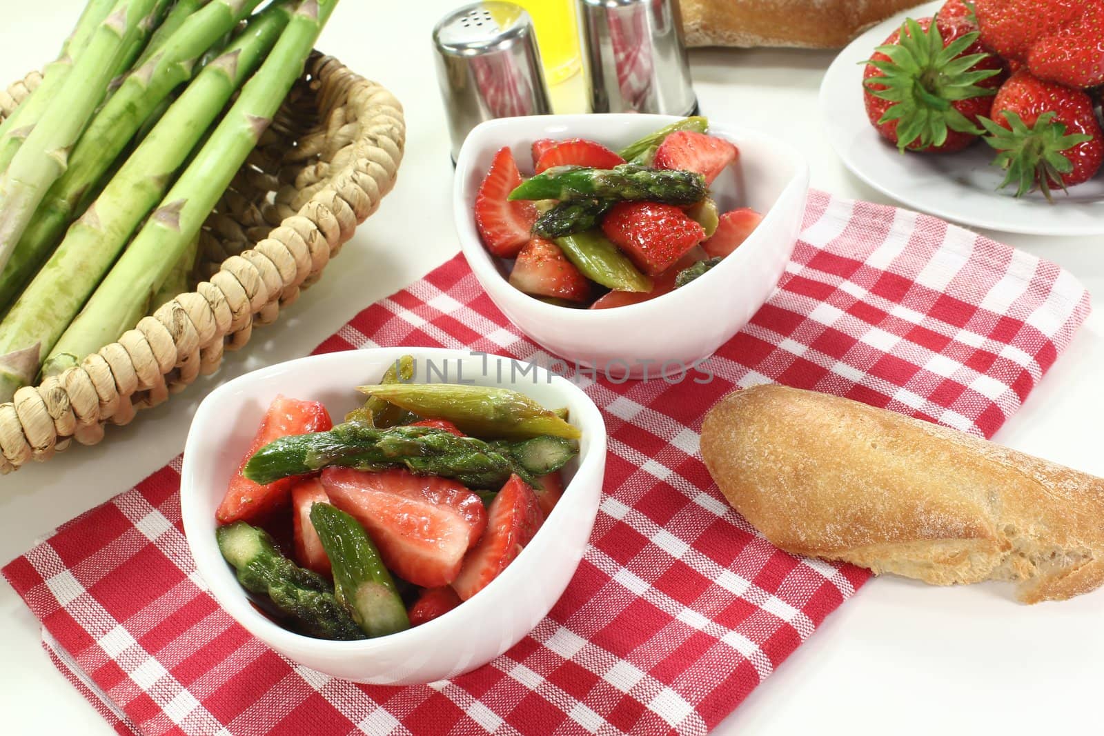 Asparagus salad with fresh strawberries, salt and pepper