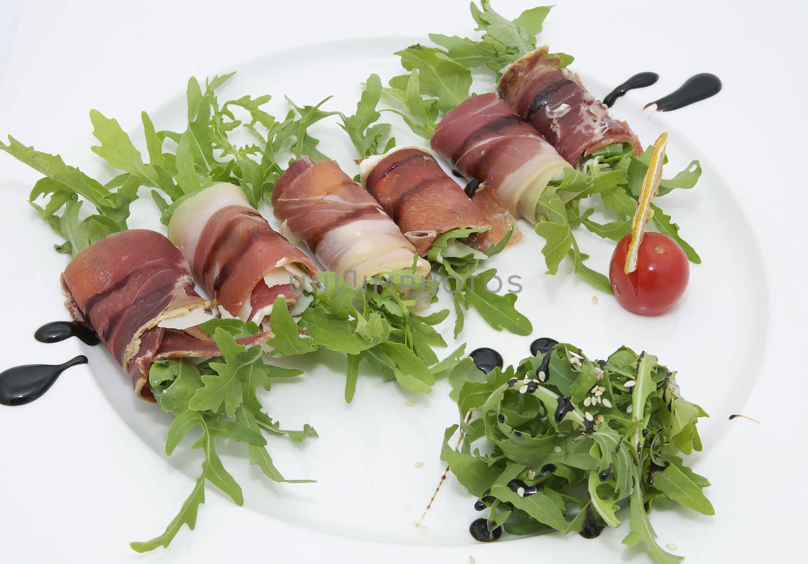 rolls of meat and greens on a white background in the restaurant