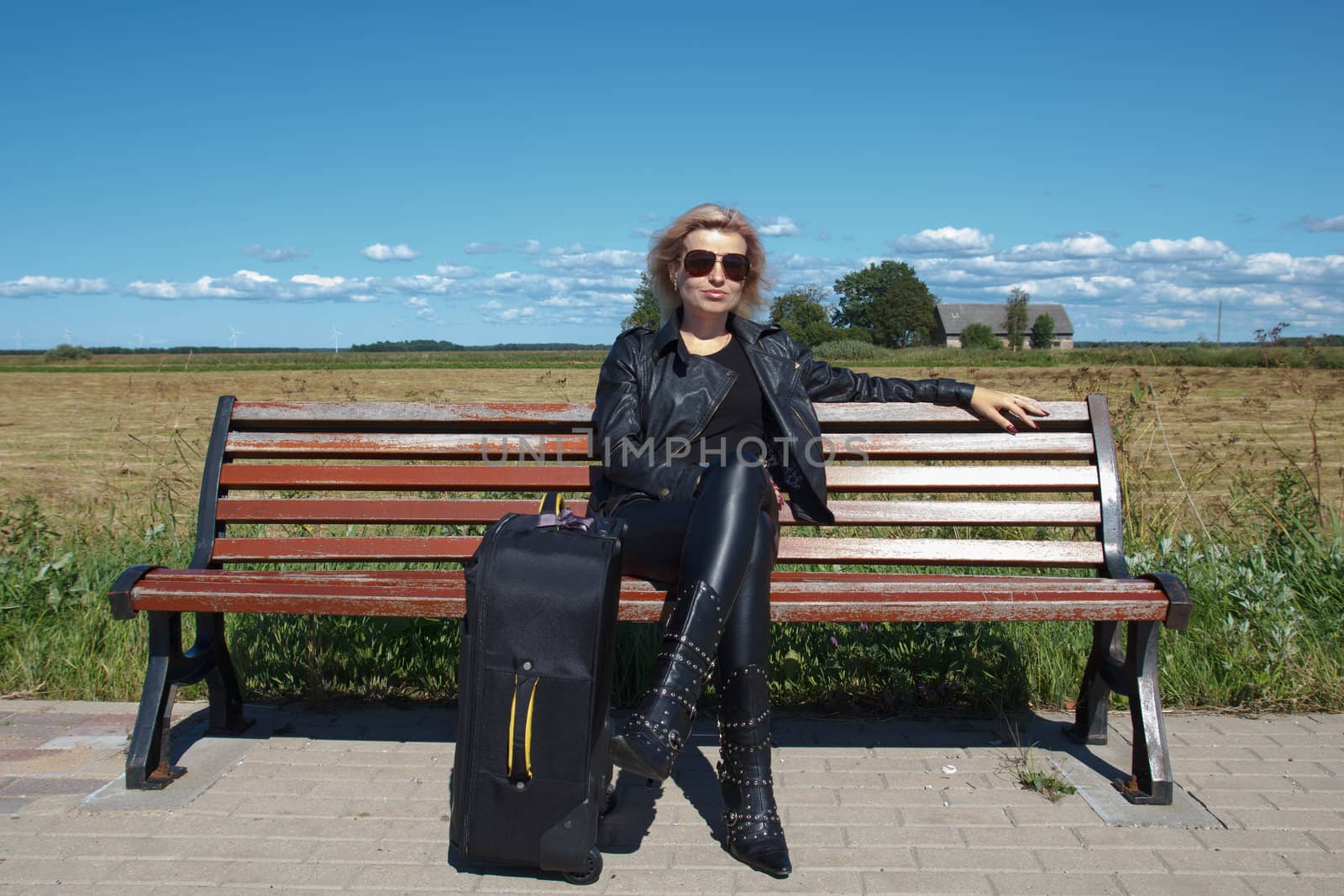 lonely bus stop at countryside with women on bench