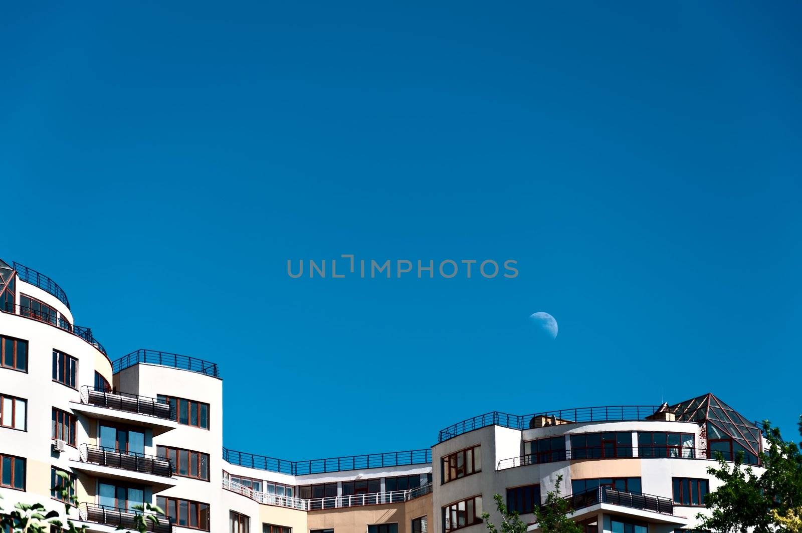 Modern house on a background of blue sky and the moon