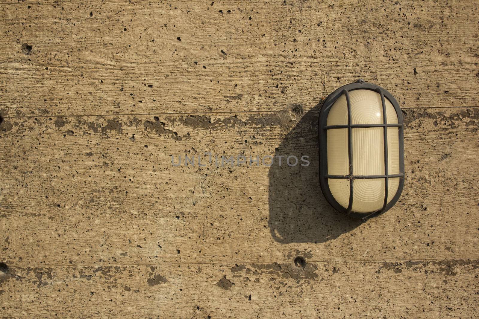 A wall light on a distressed wall by jeremywhat