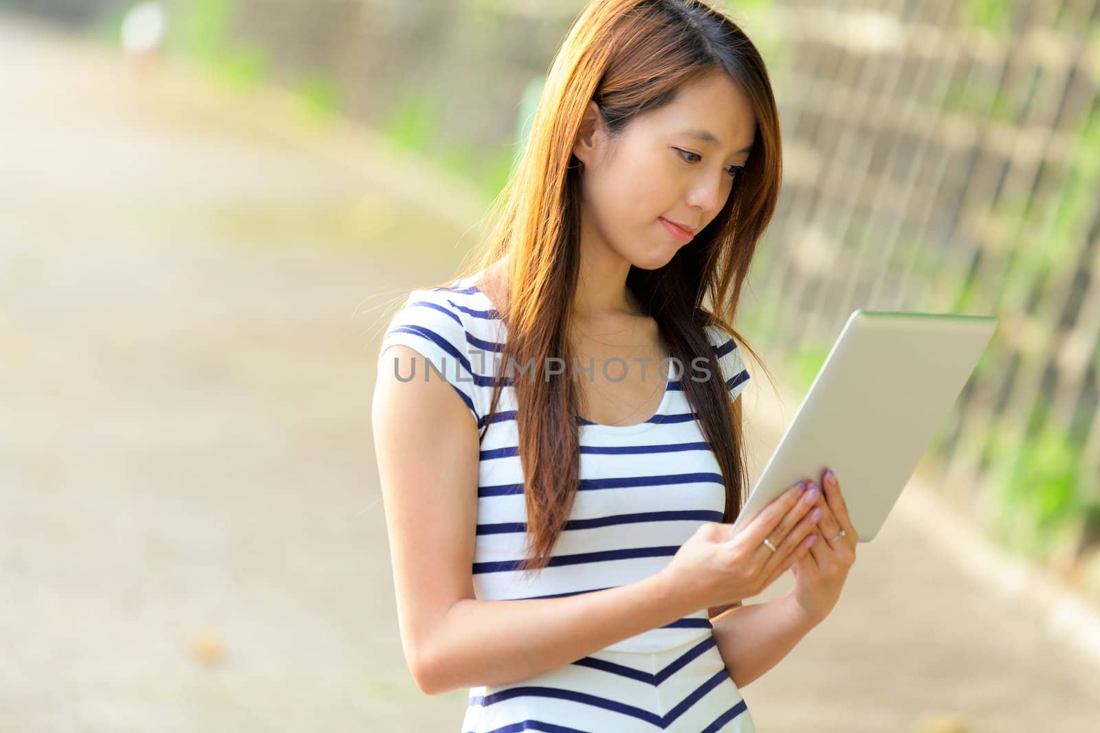 woman using tablet computer by leungchopan