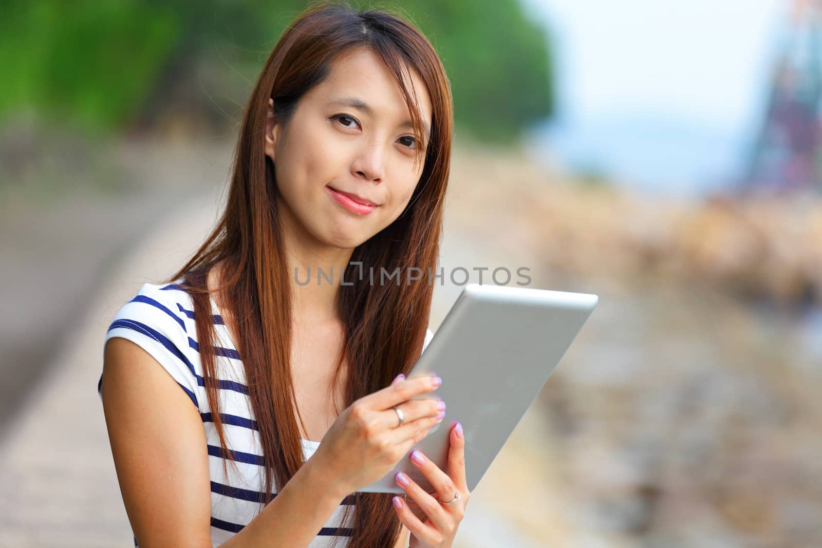 woman using tablet computer by leungchopan