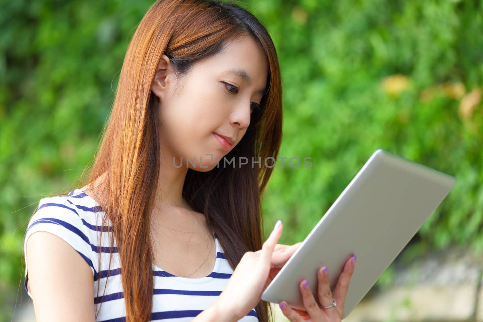 woman using tablet computer by leungchopan