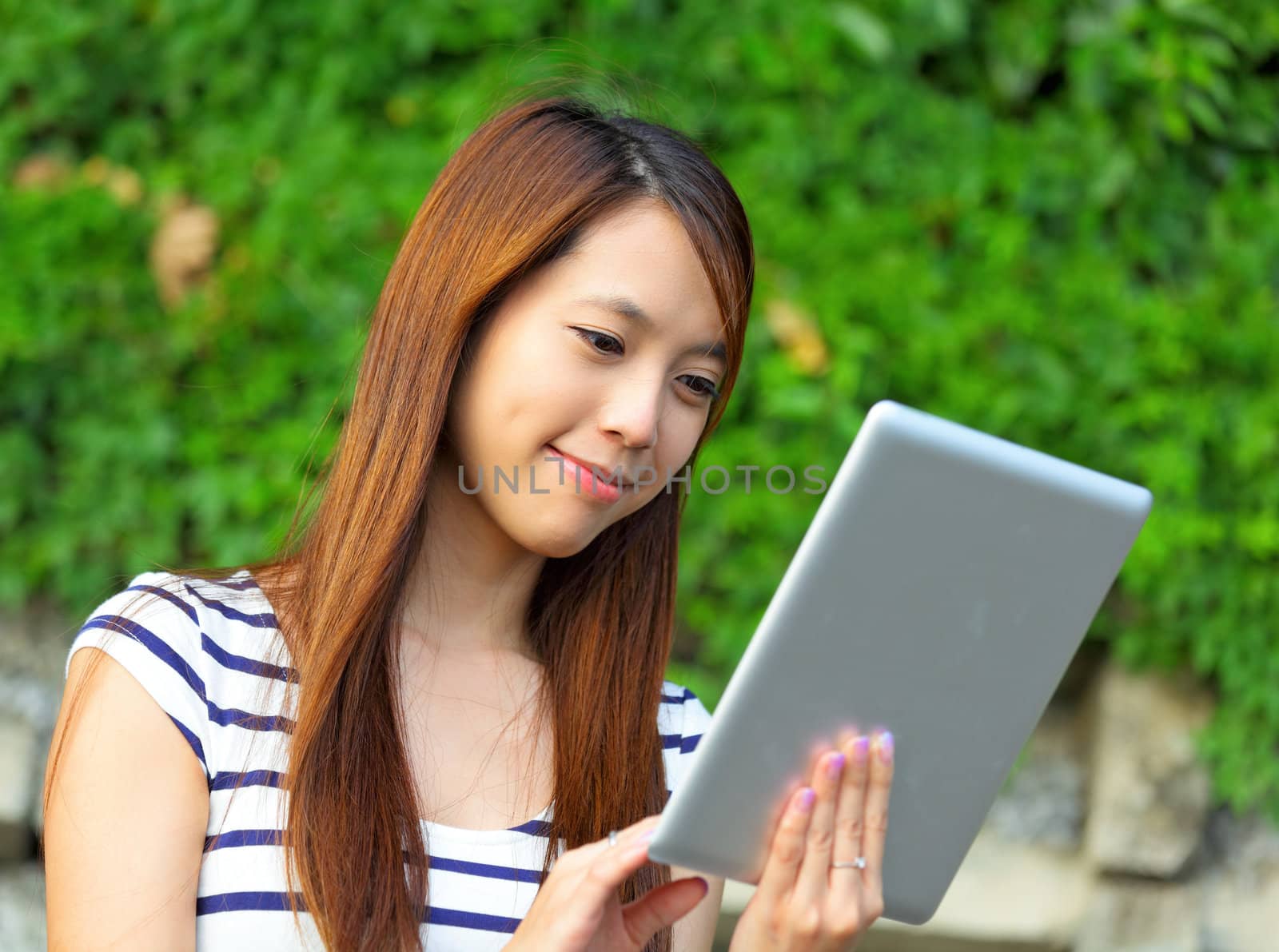 young woman using tablet touch computer by leungchopan