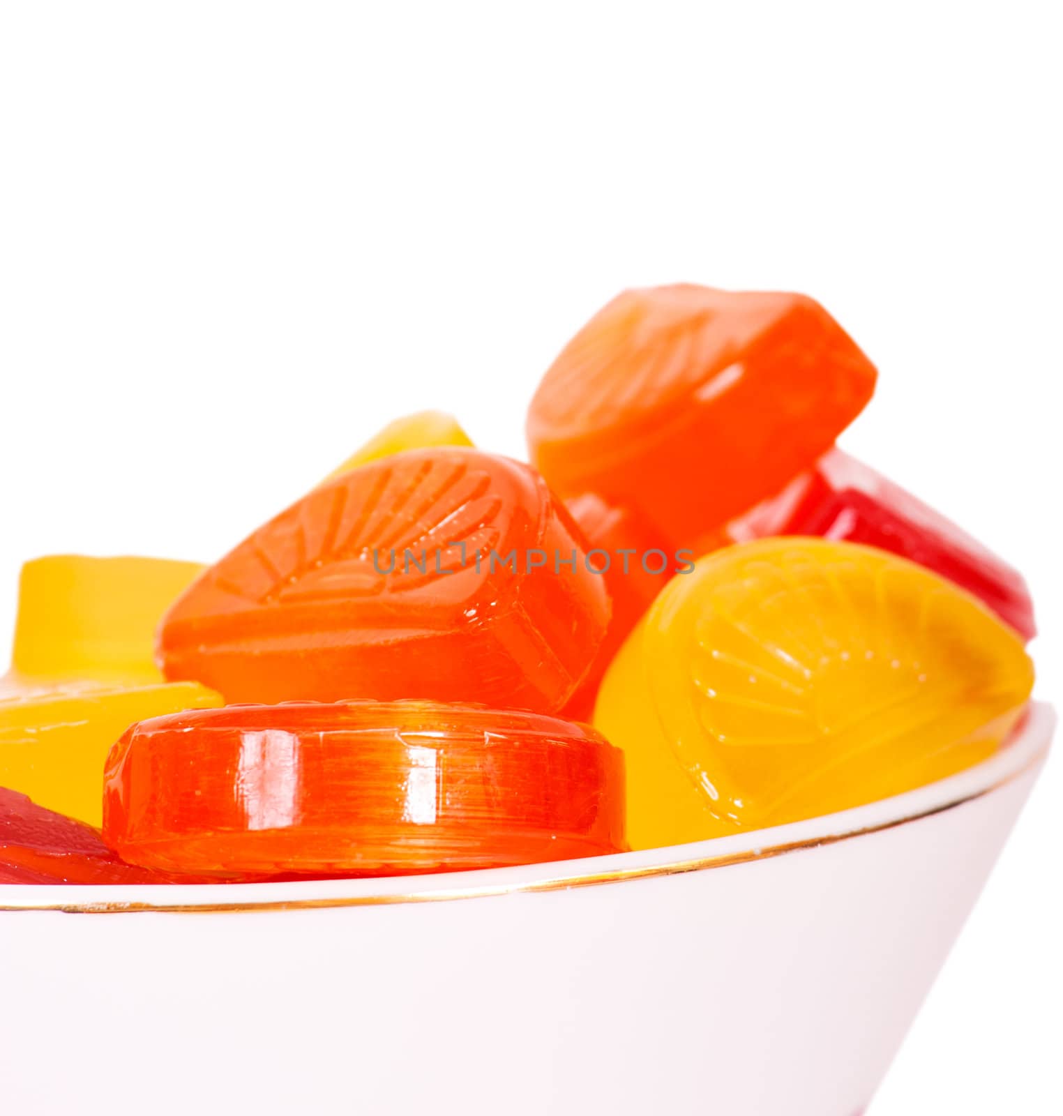 Candies in a bowl isolated on white background