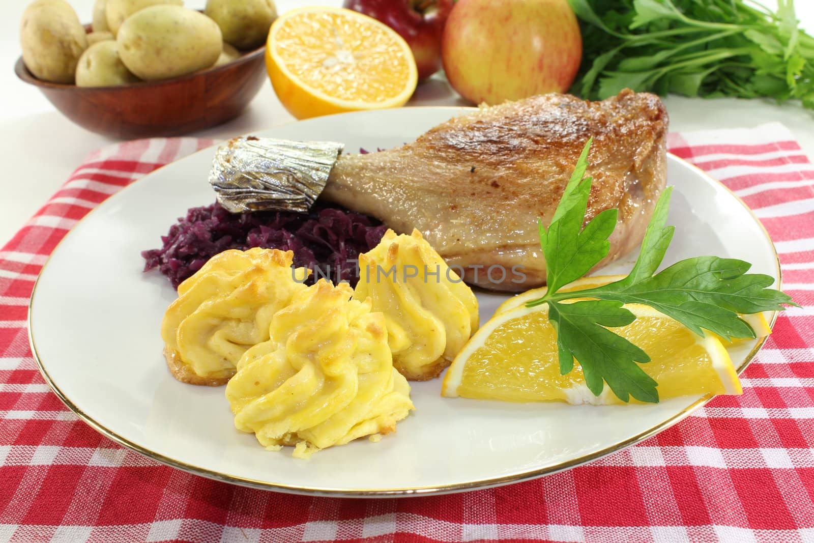 Duck leg with red cabbage and duchess potatoes