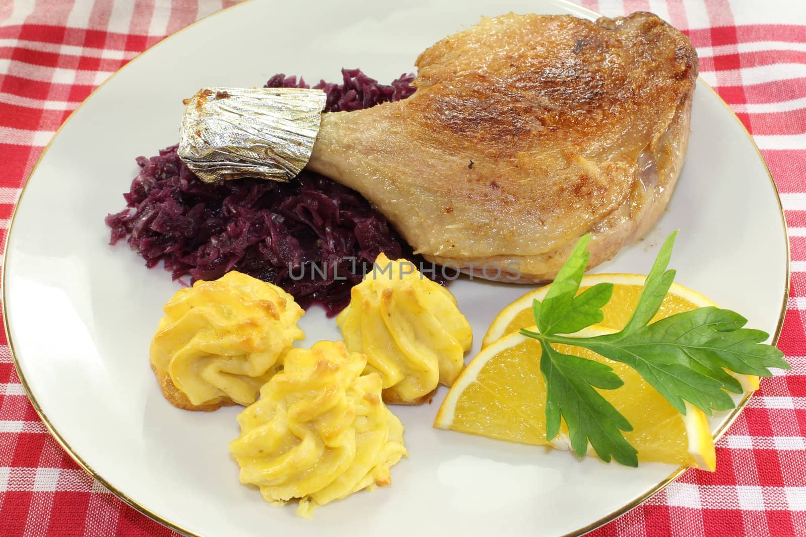 Duck leg with red cabbage and duchess potatoes