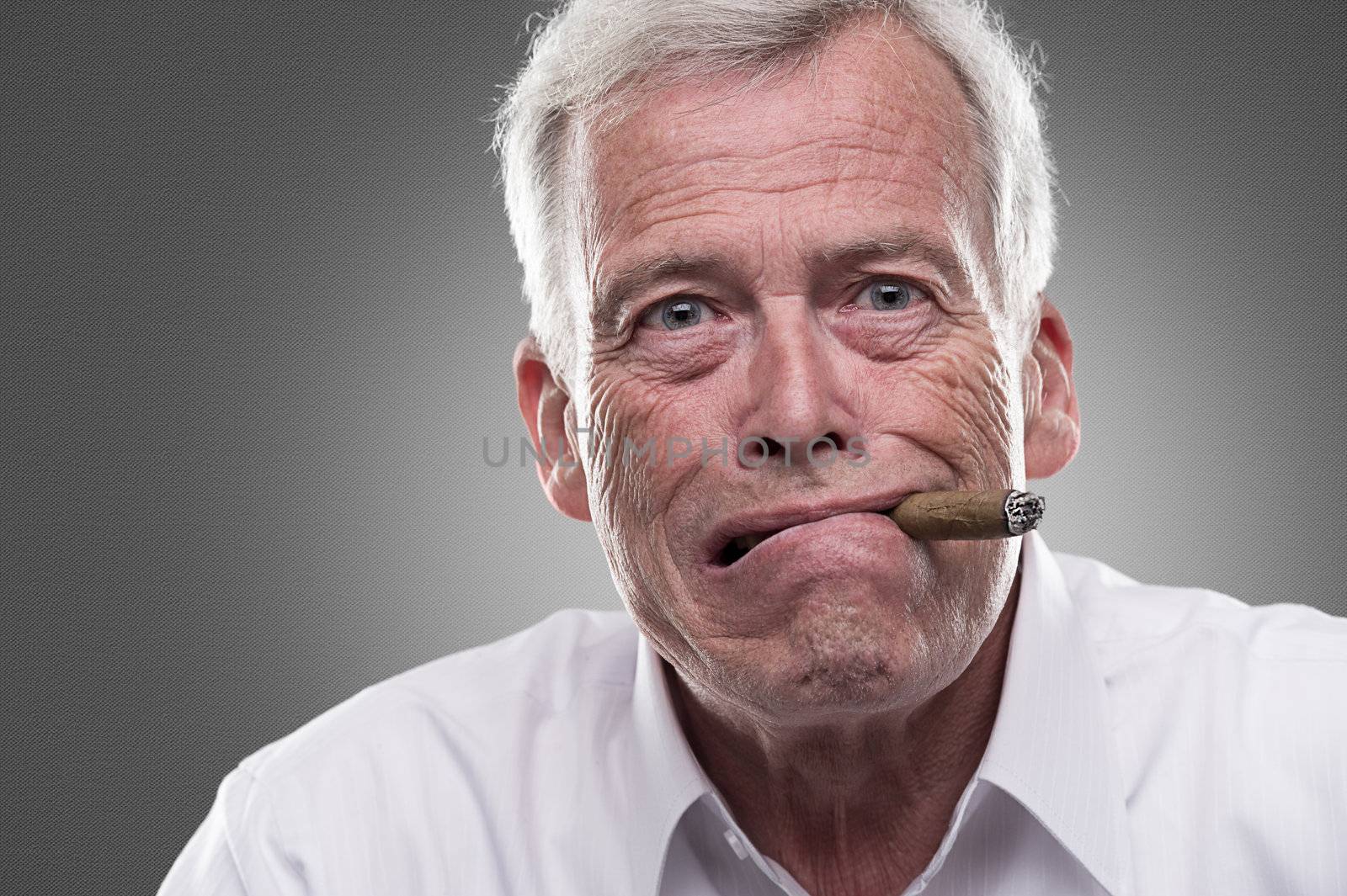 Studio shot of puzzled senior man with cigar in his mouth






Puzzled man with cigar in mouth