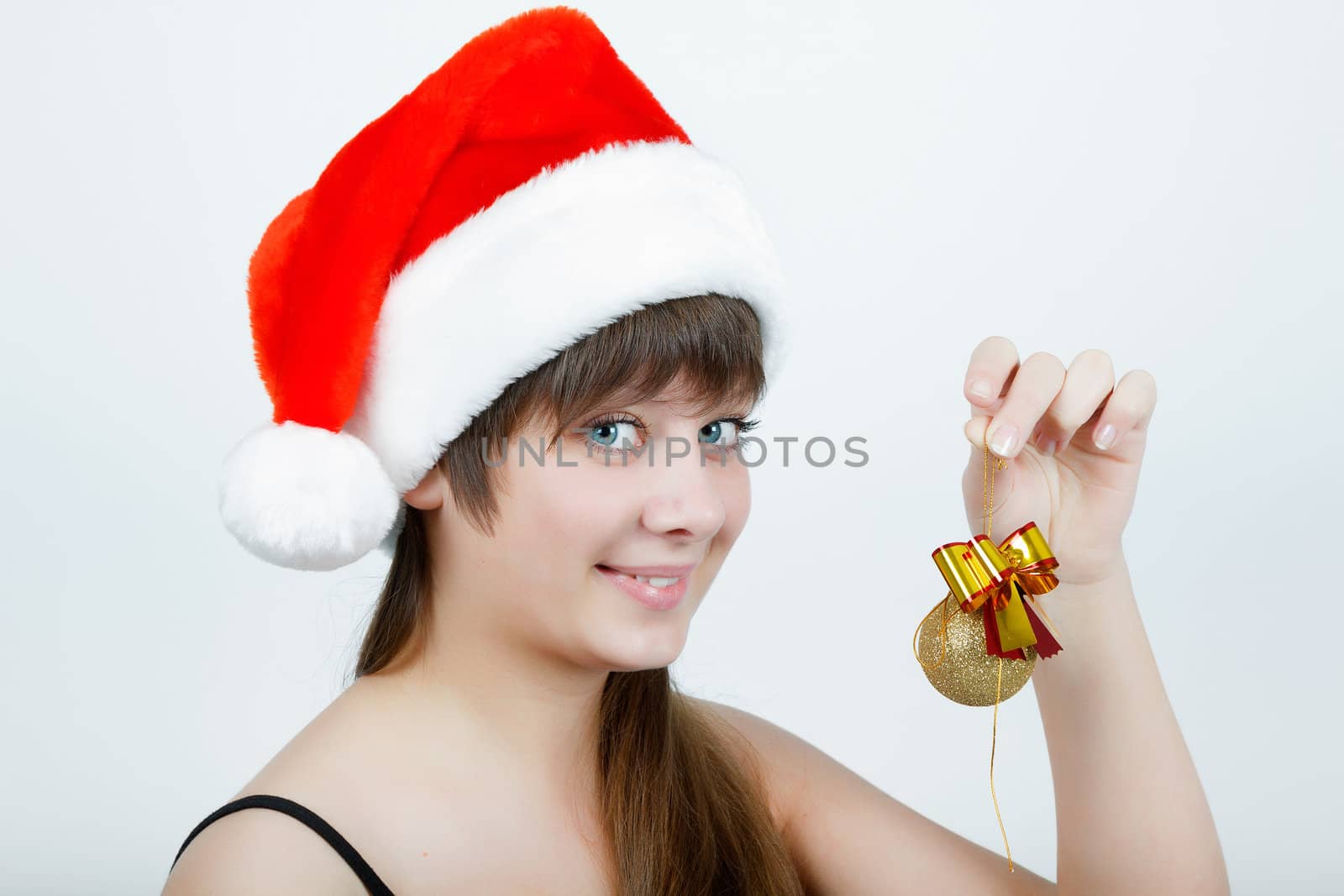 attractive girl in a Christmas hat with Christmas decorations